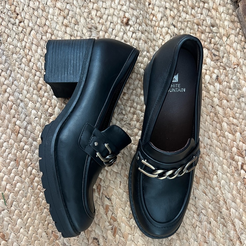 Black heeled loafers with gold chain detail